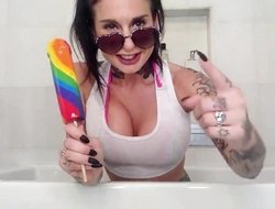 Dark-haired slut with fake boobs fucks yourself in the bathroom